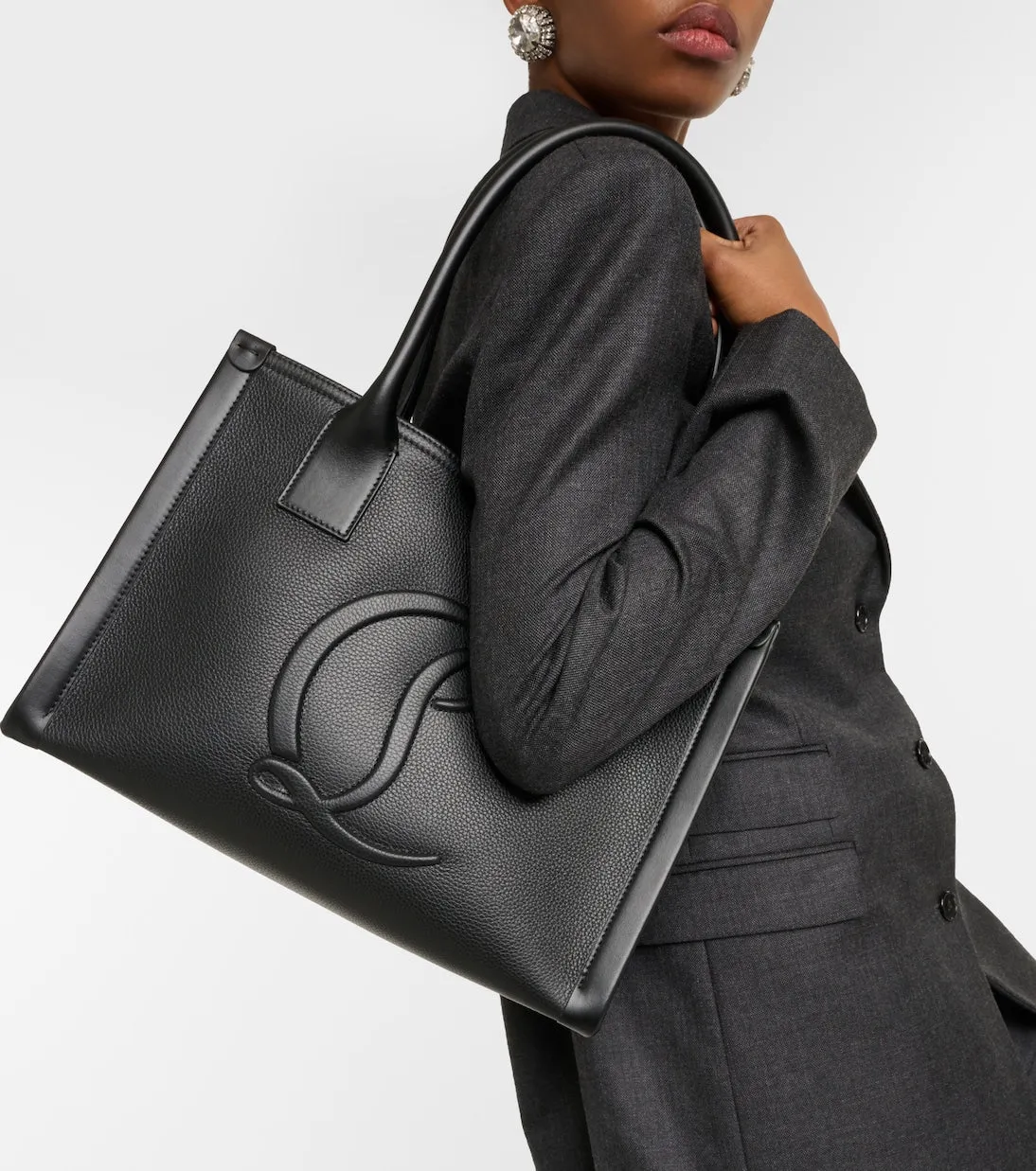 Next to me is a large Christian Louboutin leather tote bag, black.